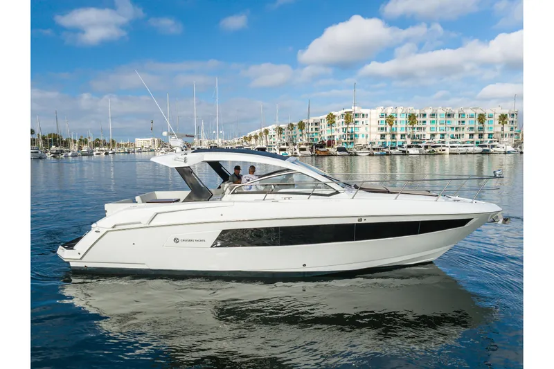 The Image of 2017 Cruisers Yachts 39 Express Coupe on calm water, marina background. - 1
