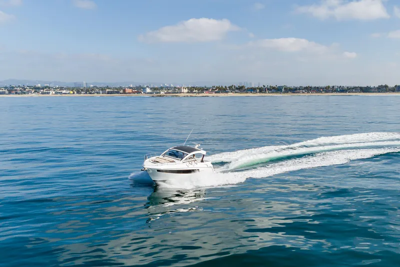 Slide: The Image of 2017 Cruisers Yachts 39 Express Coupe cruising on calm ocean waters. - 12