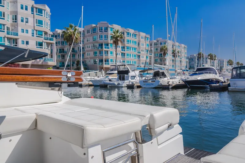 Slide: The Image of 2017 Cruisers Yachts 39 Express Coupe docked in a marina with waterfront buildings. - 29