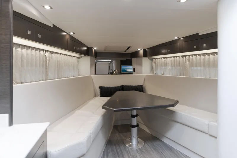 Slide: The Image of 2017 Cruisers Yachts 39 Express Coupe interior with modern seating and table. - 35