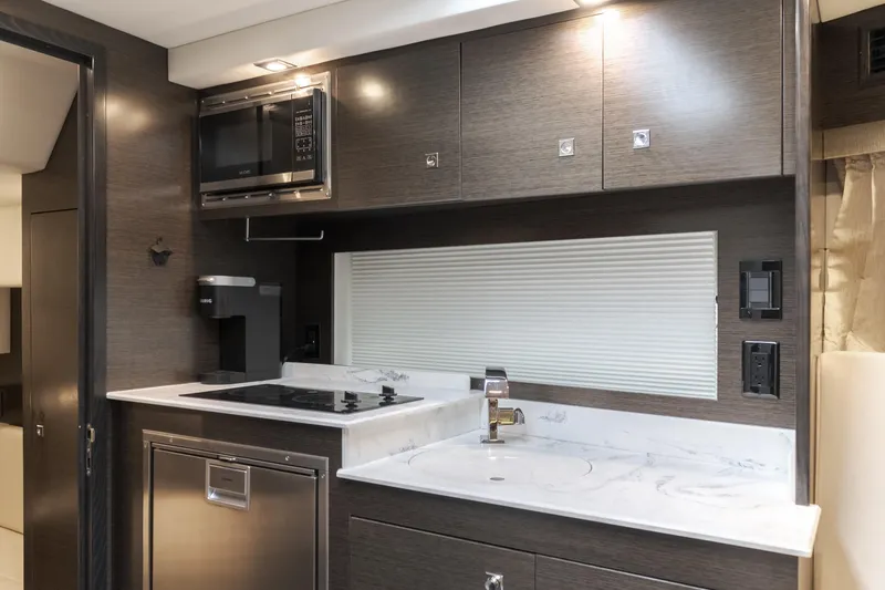 Slide: The Image of 2017 Cruisers Yachts 39 Express Coupe kitchen with modern appliances and sleek cabinetry. - 40
