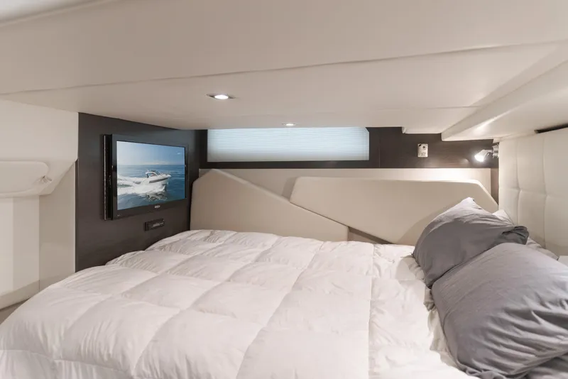 Slide: The Image of Luxurious cabin interior of 2017 Cruisers Yachts 39 Express Coupe with TV and cozy bedding. - 41