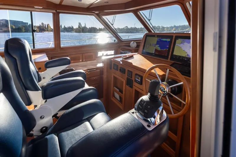 Slide: The Image of Interior of 2020 Sabre 45 Salon Express yacht with navigation screens and leather seating. - 22