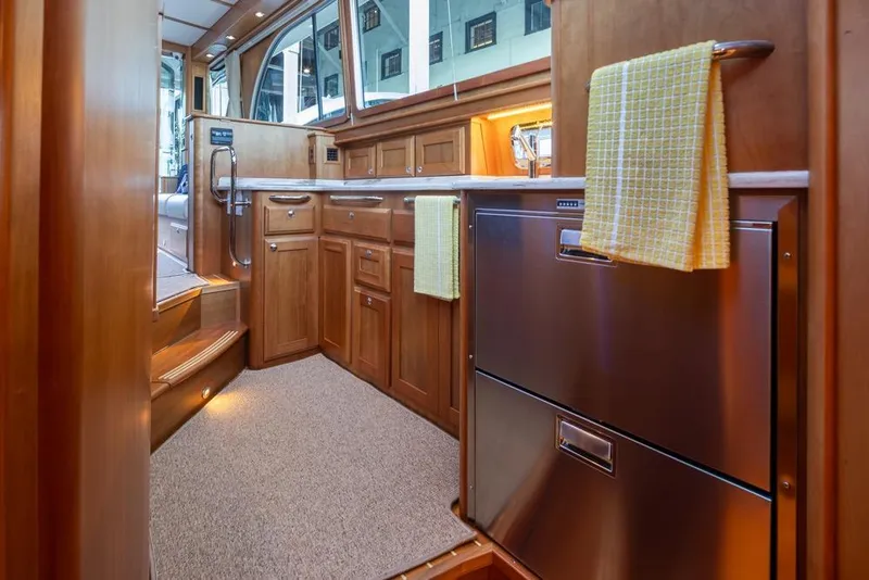 Slide: The Image of Interior of 2020 Sabre 45 Salon Express yacht with wooden cabinetry and stainless steel appliances. - 25