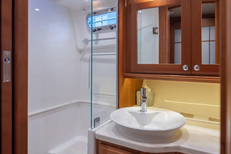 Slide: The Image of Luxurious bathroom interior of 2020 Sabre 45 Salon Express yacht, featuring elegant wood cabinetry. - 35