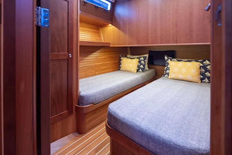 Slide: The Image of 2020 Sabre 45 Salon Express cabin with twin beds and wooden interior. - 36
