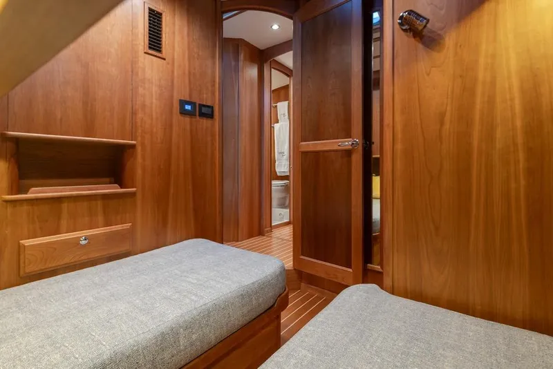 Slide: The Image of Interior of 2020 Sabre 45 Salon Express yacht, featuring wooden cabinetry and cozy seating. - 37