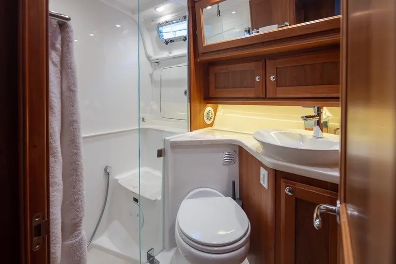 Slide: The Image of Luxurious bathroom in 2020 Sabre 45 Salon Express yacht with wood cabinetry and modern fixtures. - 38