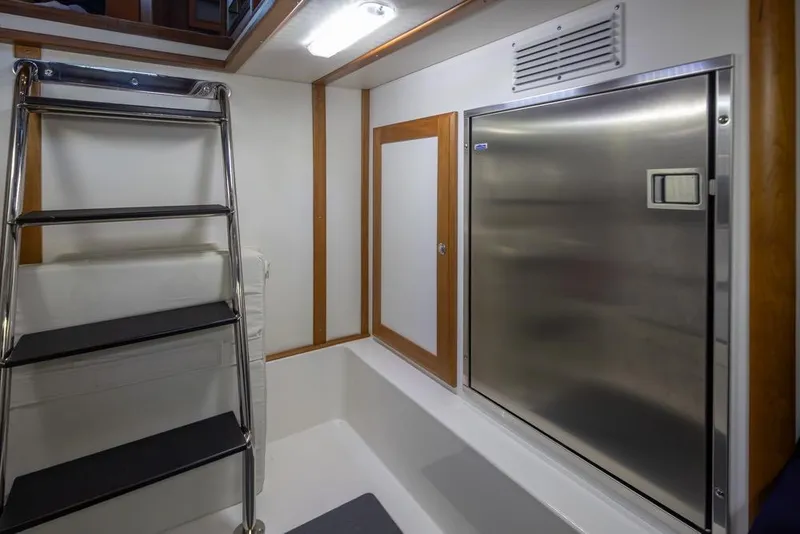 Slide: The Image of Interior of 2020 Sabre 45 Salon Express yacht, featuring a stainless steel appliance and ladder. - 42