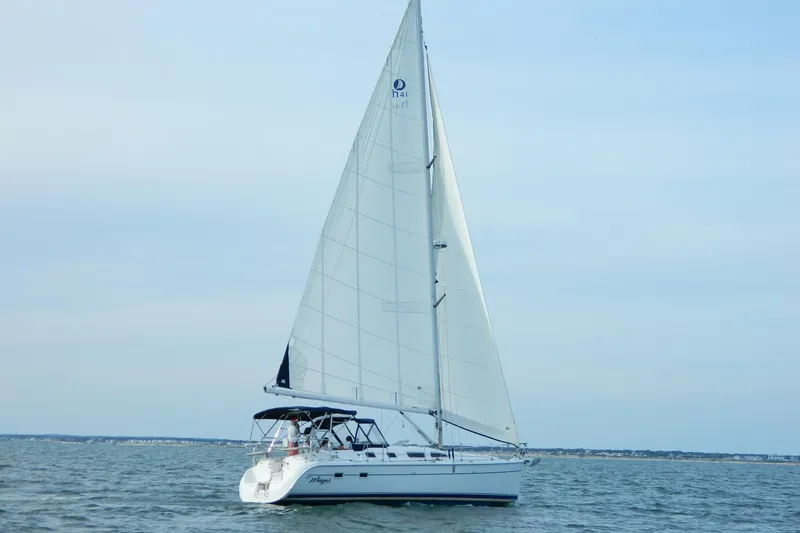 The Image of 2007 Hunter 41 AC sailboat cruising on open water under clear skies. - 0