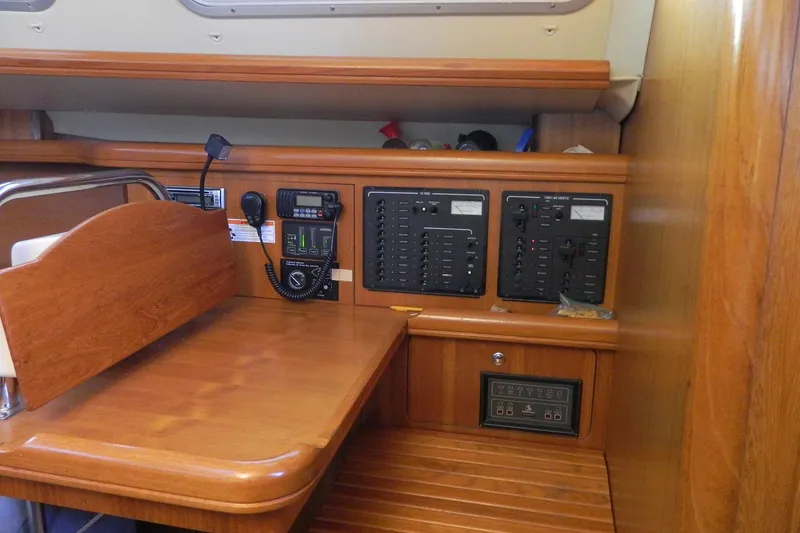 Slide: The Image of Navigation station of 2007 Hunter 41 AC sailboat with control panels and radio. - 13