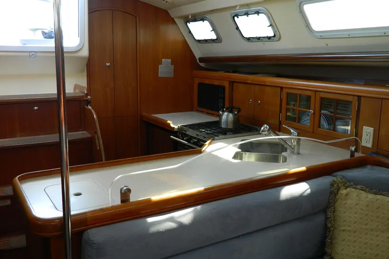 Slide: The Image of Interior of 2007 Hunter 41 AC yacht with modern kitchen and wooden cabinetry. - 17