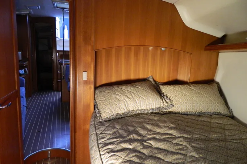 Slide: The Image of Cozy cabin interior of 2007 Hunter 41 Aft Cockpit sailboat with wood paneling and bedding. - 23