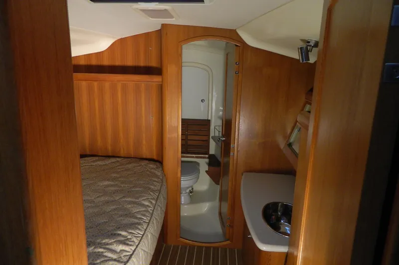 Slide: The Image of Interior of 2007 Hunter 41 Aft Cockpit yacht with wood paneling and compact bathroom. - 24