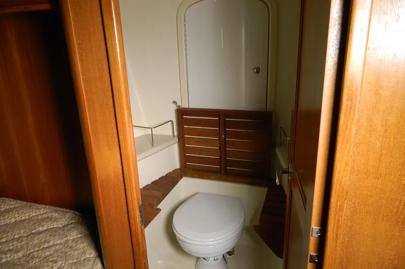 Slide: The Image of 2007 Hunter 41 Aft Cockpit yacht bathroom with wooden accents and compact design. - 25