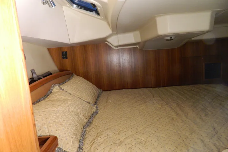 Slide: The Image of Cozy cabin interior of 2007 Hunter 41 Aft Cockpit sailboat with wood paneling and bedding. - 27
