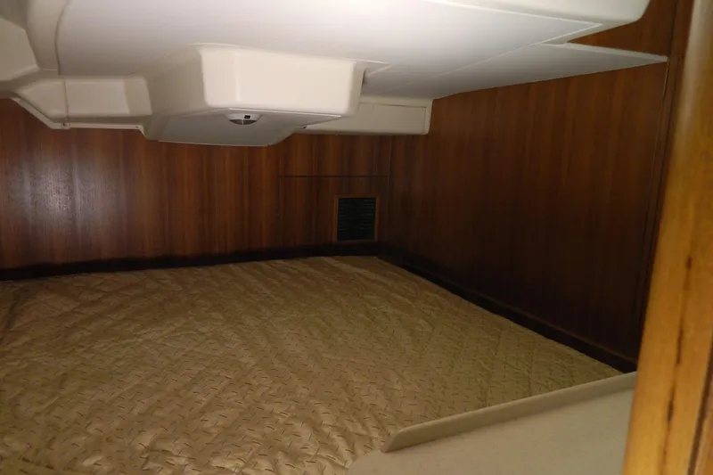 Slide: The Image of Interior cabin of 2007 Hunter 41 Aft Cockpit yacht with wood paneling and bedding. - 28