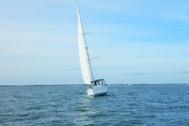 Slide: The Image of Sailboat Hunter 41 AC 2007 navigating on open water under clear skies. - 3