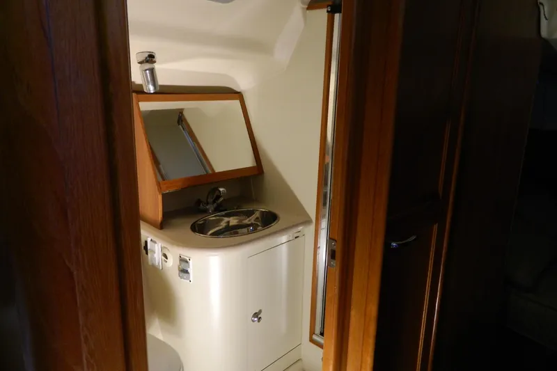Slide: The Image of Compact bathroom in 2007 Hunter 41 Aft Cockpit yacht with sink and mirror. - 32