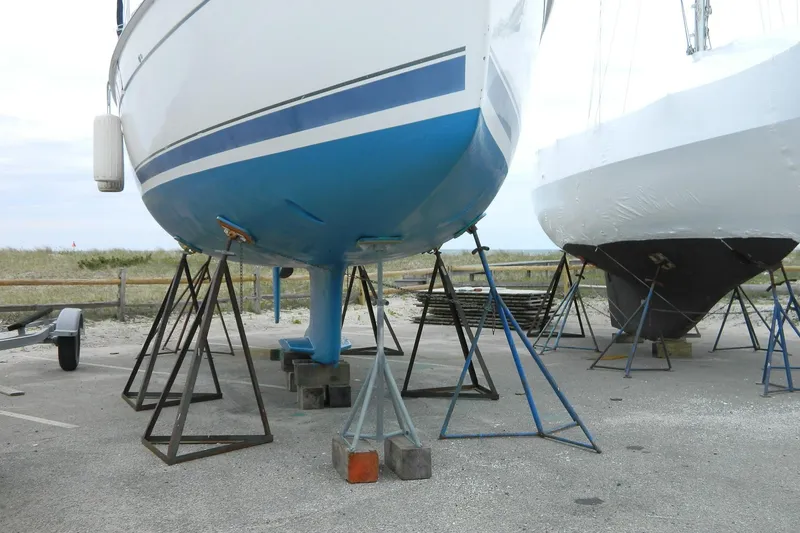 Slide: The Image of 2007 Hunter 41 Aft Cockpit sailboat on stands, blue hull, outdoor storage. - 34