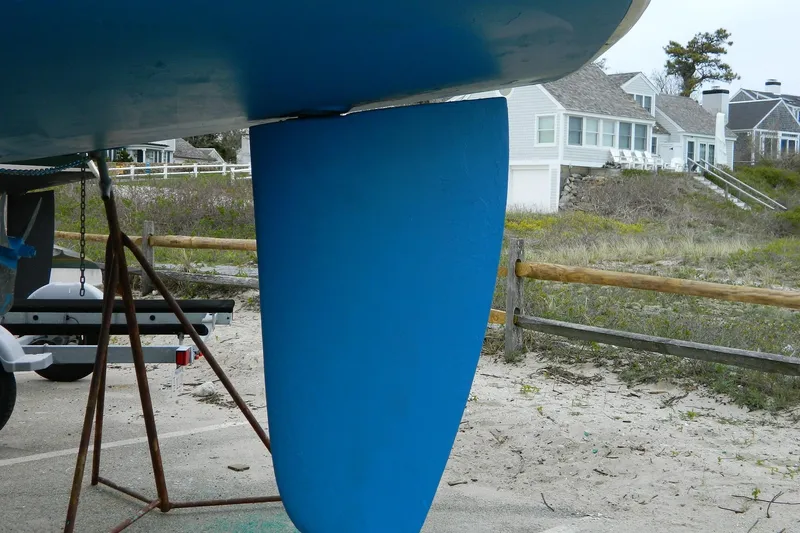 Slide: The Image of Blue rudder of 2007 Hunter 41 Aft Cockpit sailboat on sandy beach background. - 35