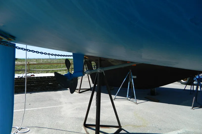 Slide: The Image of 2007 Hunter 41 Aft Cockpit sailboat on stands, showing propeller and hull. - 36