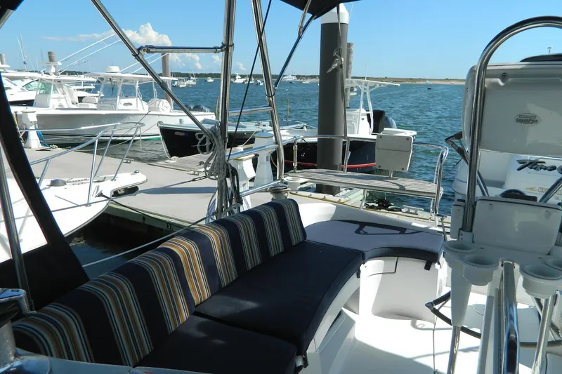 Slide: The Image of 2007 Hunter 41 AC sailboat interior with striped seating, docked at marina. - 7