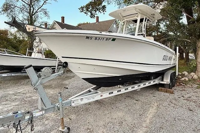 Slide: The Image of 2018 Boston Whaler 230 Outrage boat on trailer, parked outdoors. - 1