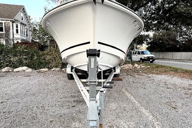 Slide: The Image of 2018 Boston Whaler 230 Outrage boat on trailer, parked outdoors. - 4