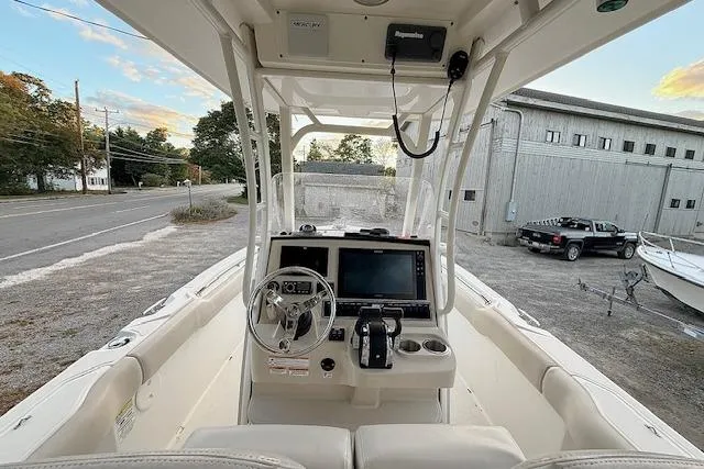 Slide: The Image of 2018 Boston Whaler 230 Outrage boat cockpit with steering wheel and navigation system. - 9