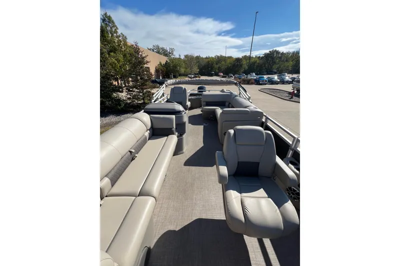 Slide: The Image of 2024 Sun Tracker SportFish 20 DLX pontoon boat with spacious seating and modern design. - 5