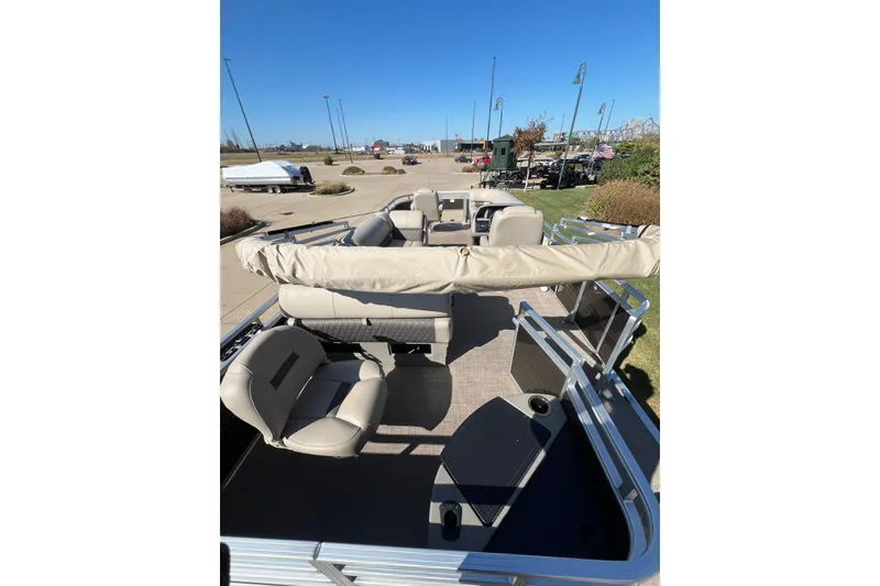 Slide: The Image of 2024 Sun Tracker SportFish 20 DLX pontoon boat with beige seating and open deck layout. - 6