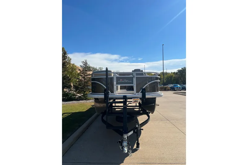 Slide: The Image of 2024 Sun Tracker SportFish 20 DLX pontoon boat on trailer under clear blue sky. - 7