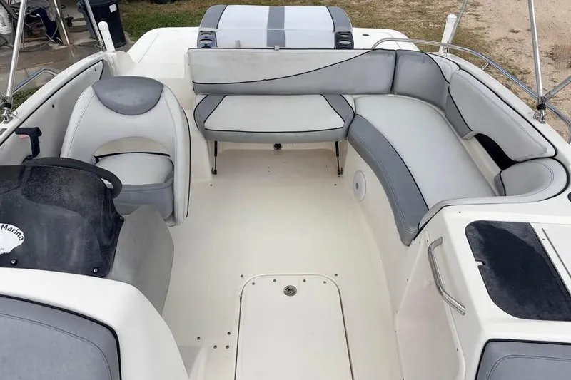 Slide: The Image of 2007 Bayliner 217 Deck Boat interior with gray seating and steering console. - 5