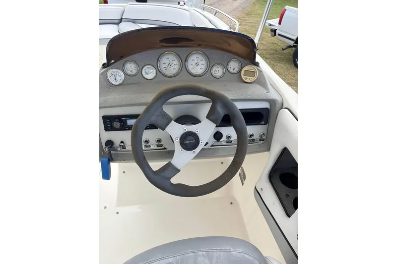 Slide: The Image of 2007 Bayliner 217 Deck Boat dashboard with steering wheel and gauges. - 6