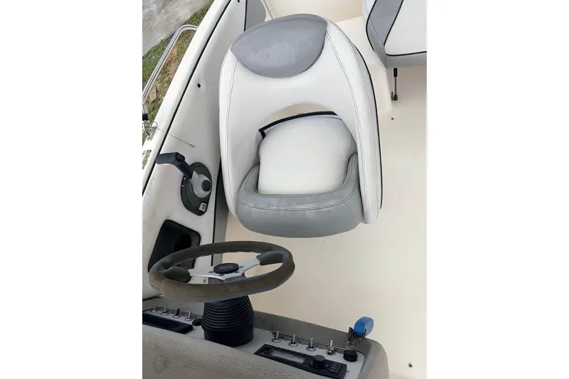 Slide: The Image of 2007 Bayliner 217 Deck Boat interior with steering wheel and captain's chair. - 7