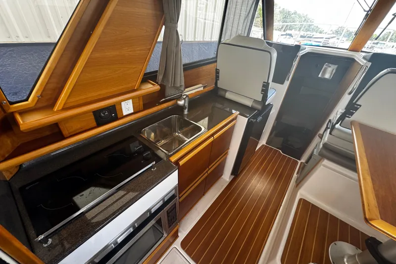 Slide: The Image of 2019 Cutwater C-28 boat interior with modern kitchen, wood accents, and sleek design. - 4