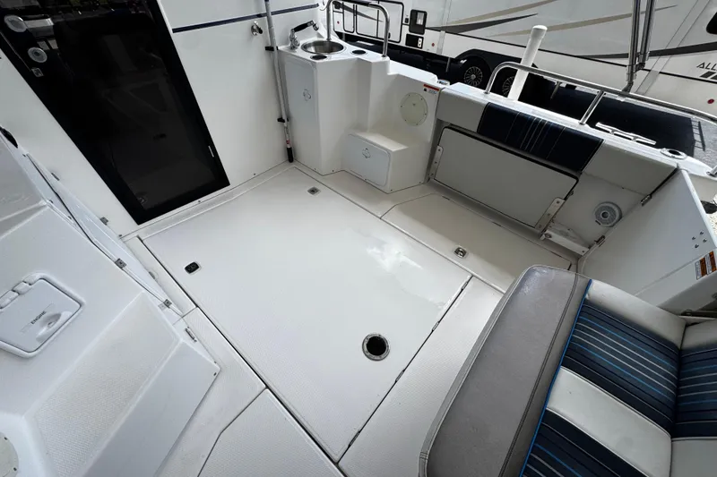 Slide: The Image of 2019 Cutwater C-28 boat interior with seating and sink area. - 6