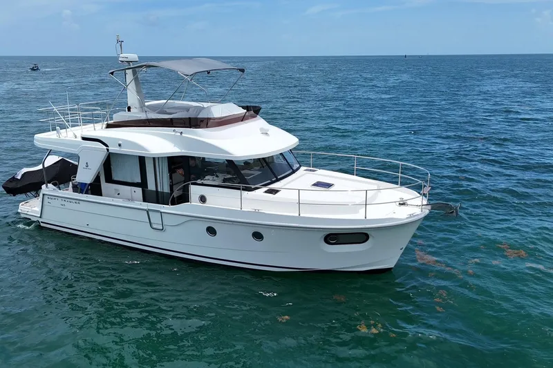 Slide: The Image of 2021 Beneteau Swift Trawler 41 Fly cruising on open sea under clear skies. - 0