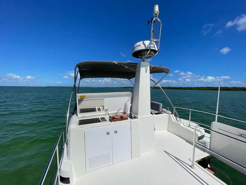 Slide: The Image of 2021 Beneteau Swift Trawler 41 Fly on open water, featuring spacious deck and navigation equipment. - 11