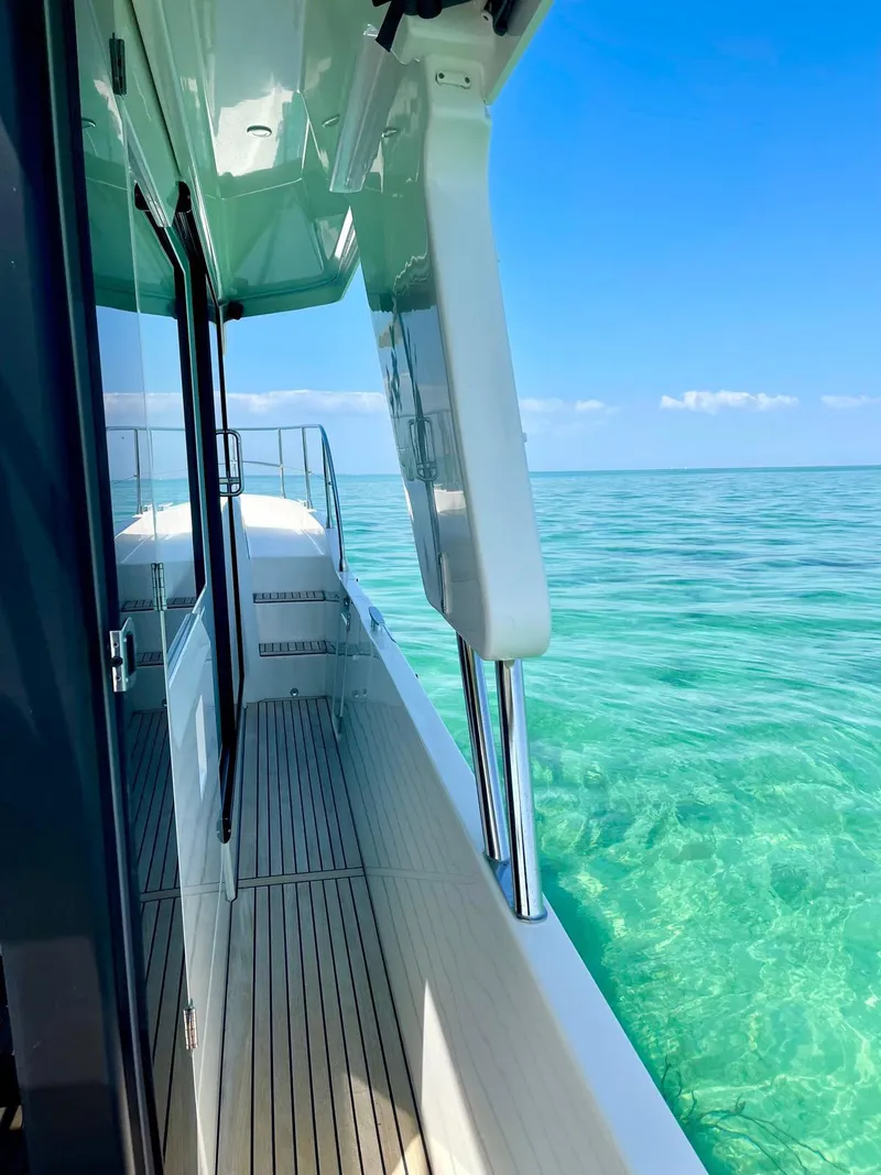 Slide: The Image of 2021 Beneteau Swift Trawler 41 Fly on clear turquoise water, side deck view. - 12