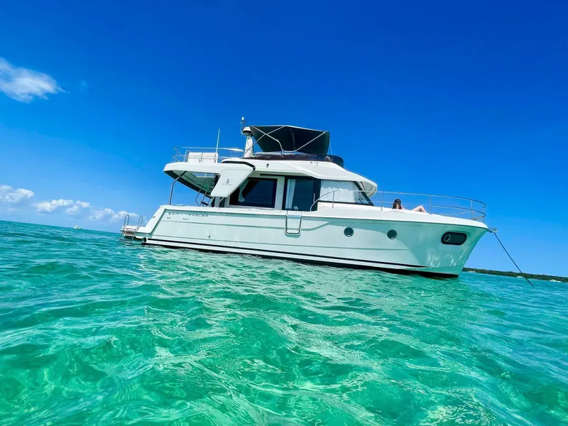 Slide: The Image of 2021 Beneteau Swift Trawler 41 Fly on clear turquoise water under blue sky. - 13