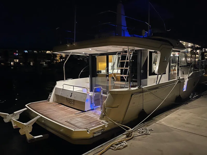 Slide: The Image of 2021 Beneteau Swift Trawler 41 Fly docked at night, illuminated deck. - 15