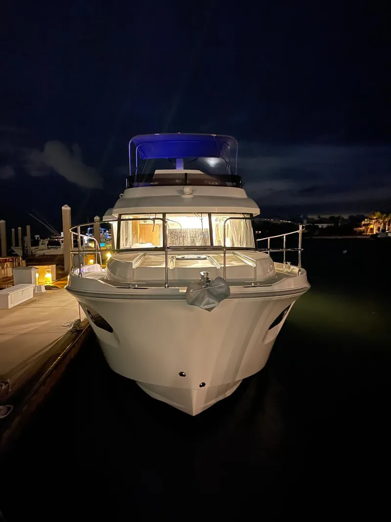 Slide: The Image of 2021 Beneteau Swift Trawler 41 Fly docked at night, illuminated and ready for adventure. - 16