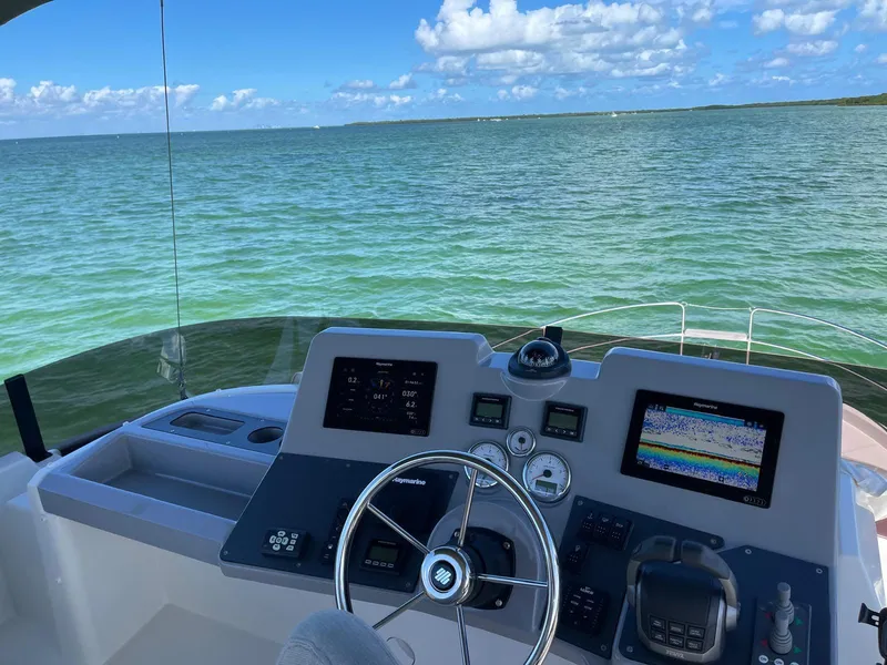 Slide: The Image of Beneteau Swift Trawler 41 Fly 2021 helm with ocean view and navigation equipment. - 18