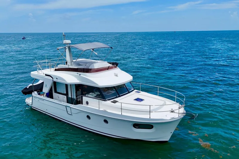 Slide: The Image of 2021 Beneteau Swift Trawler 41 Fly cruising on open blue sea. - 2