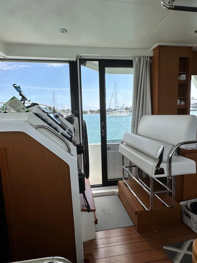 Slide: The Image of Interior view of 2021 Beneteau Swift Trawler 41 Fly, featuring helm and seating area. - 21