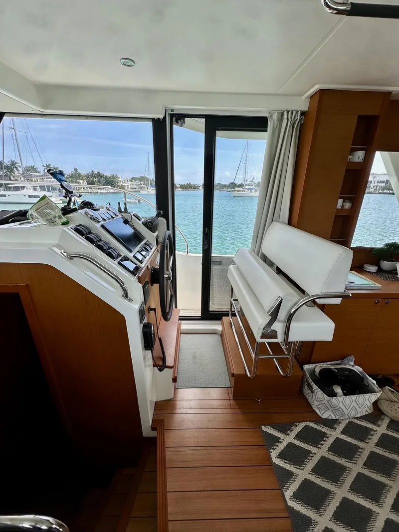 Slide: The Image of Interior of 2021 Beneteau Swift Trawler 41 Fly, featuring helm and seating area. - 23