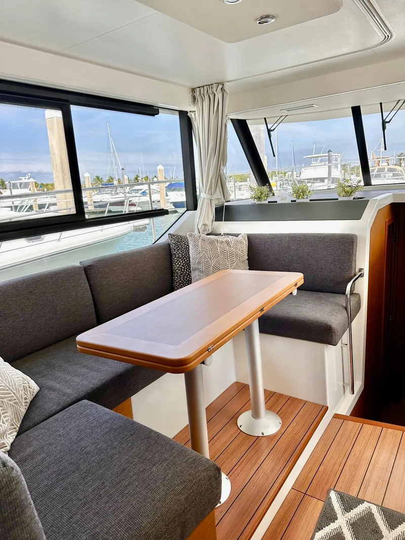 Slide: The Image of Interior of 2021 Beneteau Swift Trawler 41 Fly with modern seating and table. - 24
