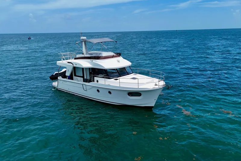 Slide: The Image of 2021 Beneteau Swift Trawler 41 Fly cruising on open blue sea. - 3